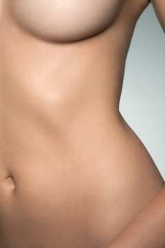 Closeup view of a naked woman's torso.