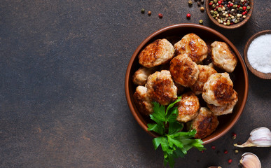 Meat balls with spices on a concrete background. View from above.
