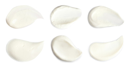 Set of delicious sour cream on white background, top view
