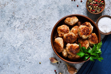 Fototapeta premium Meat balls with spices on a concrete background. View from above.