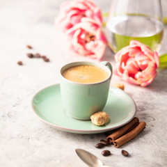 Morning coffee and spring tulips on light grey background