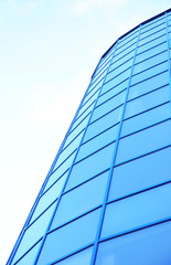 Fototapeta na wymiar Modern office building with tinted windows against blue sky