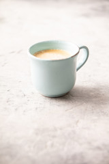 A cup of coffee on light grey background
