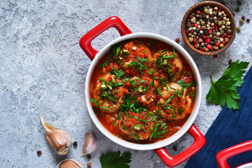 Meat balls baked in tomato sauce with spices on a concrete background. View from above.