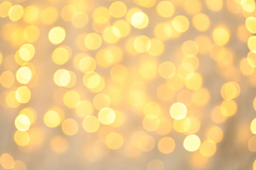 Blurred view of golden Christmas lights as background. Bokeh effect