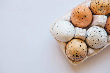 A set of eggs in a container on a white background. Easter celebration.