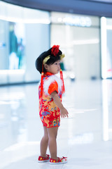 Portrait of cute little girl asian woman in Cheongsam dress,Thailand people,Happy Chinese new year concept