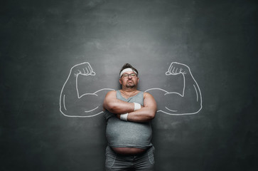 Funny sports nerd with huge muscle arms drawn on the gray background with copy space - obrazy, fototapety, plakaty
