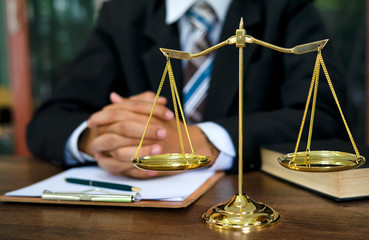 Close up lawyer businessman working or reading lawbook in office workplace for consultant lawyer...