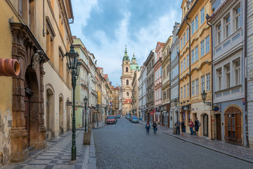 Fototapeta na wymiar Prague, Czech Republic - August 25 2018: Early morning picture of Czech street in downtown Prague with tourists