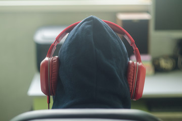 man in the hood in red headphones  