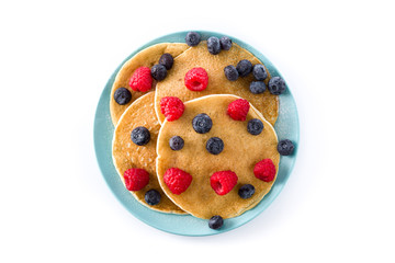 Pancakes with raspberries and blueberries isolated on white background. Top view