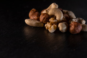 different nuts on a slate plate
