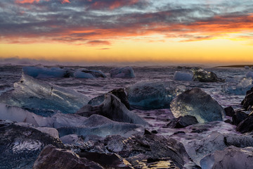 Ice floes on raging heavy sea at the shore of North Atlantic Ocean at the famous glacier lagoon in Vatnajokull National Park, Iceland