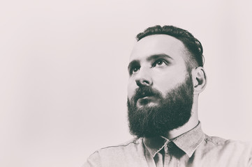 Black and white portrait of a bearded man with a stylish haircut.