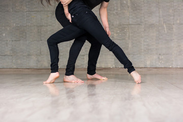 Couple of dancers in dynamic pose. Perfomance of modern dance by couple of modern style guy and girl, cropped image.