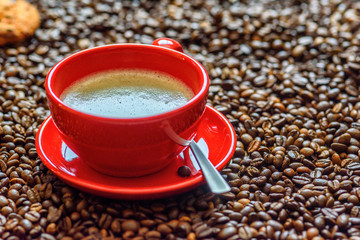 a cup of coffee on a background of coffee beans