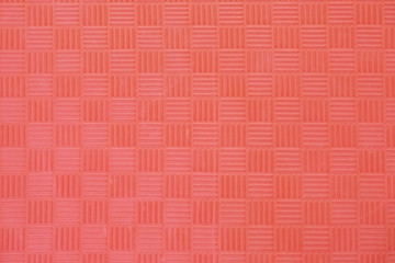 Floor covering with stripes and cubes. Soft rubberized carpets. Texture. Living coral color