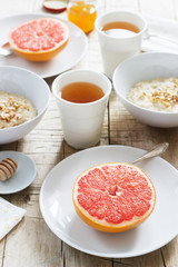 Vegetarian breakfast for two of oatmeal, baked grapefruit and tea. Rustic style.