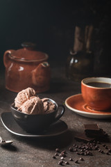 Chocolate coffee ice cream balls in a bowl over dark background