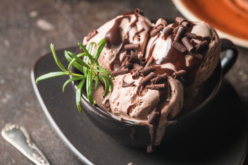 Chocolate coffee ice cream balls in a bowl over dark background