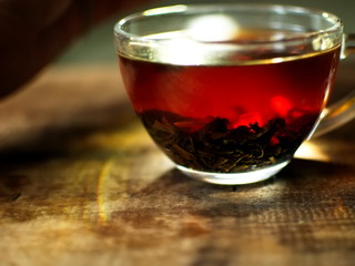 Transparent cup of golden strong tea. Glass cup with tea.