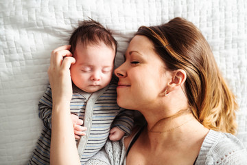 Mom and Baby having wonderful time on bed on the morning