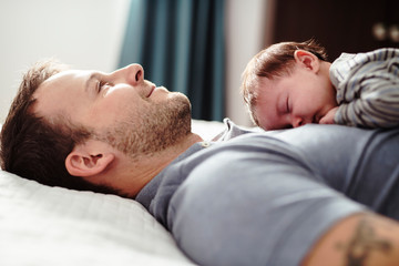 Father and Baby having wonderful time on bed on the morning