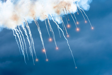 Outbreaks of warfare in the sky with explosives and smoke.