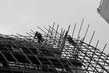 Construction workers fabricating steel reinforcement bar