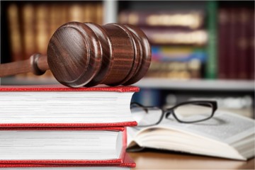 Books and wooden gavel on table. Justice concept