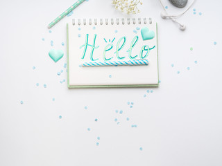Spring girl's items flat lay. Hello word