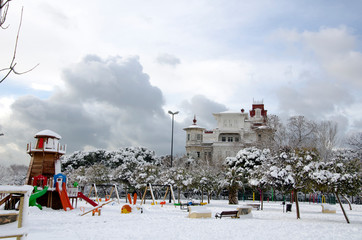 Mansion and playground under snow