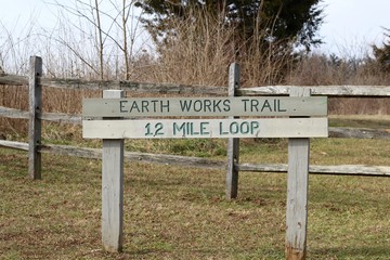 A close up view of the wooden trail sign in the park.