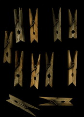 Old wooden clothespins on a black background. Vintage wooden clothespins.