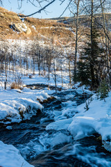 Fototapeta na wymiar Big Hills springs under snow and ice, Big Hill Springs Provincial Recreation Area, Alberta, Canada
