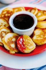 Tasty baked pancakes with strawberry jam