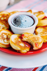 Tasty baked pancakes with strawberry jam