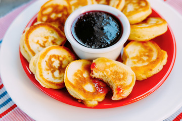Tasty baked pancakes with strawberry jam