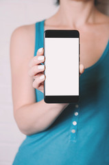 A woman holding a smartphone in her hands. Template for design or app