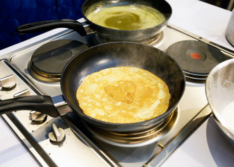 Freshly made crepe in frying pan, Crepe in the pan