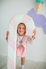 Little girl playing with big candy