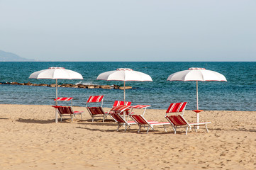 summer photography of three umbrellas still open during the sunset