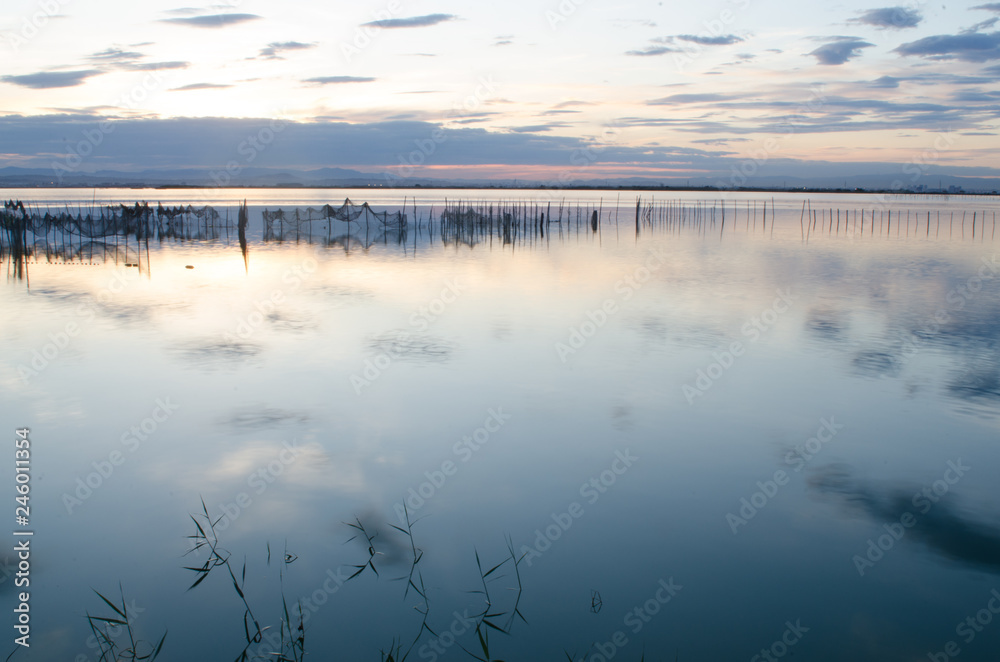 Wall mural Calm blue lake in a cloudy day