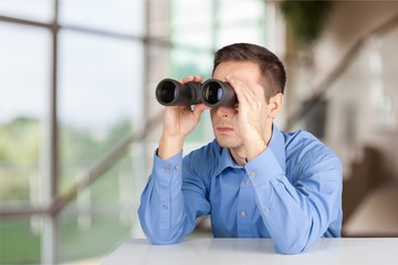 Fototapeta na wymiar Man searching in laptop. with binoculars