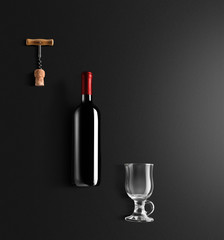 Mulled wine recipe ingredients and kitchen accessories, bottle of red wine, cinnamon, anise stars, orange, brown sugarand spice on black background.