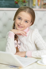 cute beautiful girl using laptop at home