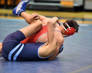 High School wrestlers competing at a wrestling meet.