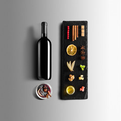 Mulled wine recipe ingredients and kitchen accessories, bottle of red wine, cinnamon, anise stars,...