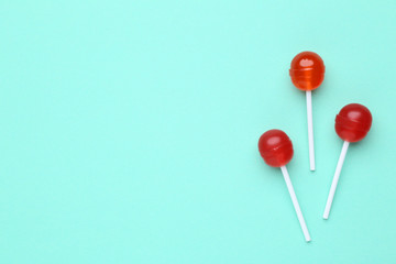 Sweet lollipops on mint background